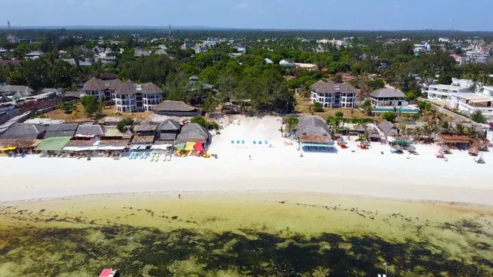 Aerial daytime view of the beach in front of the resort