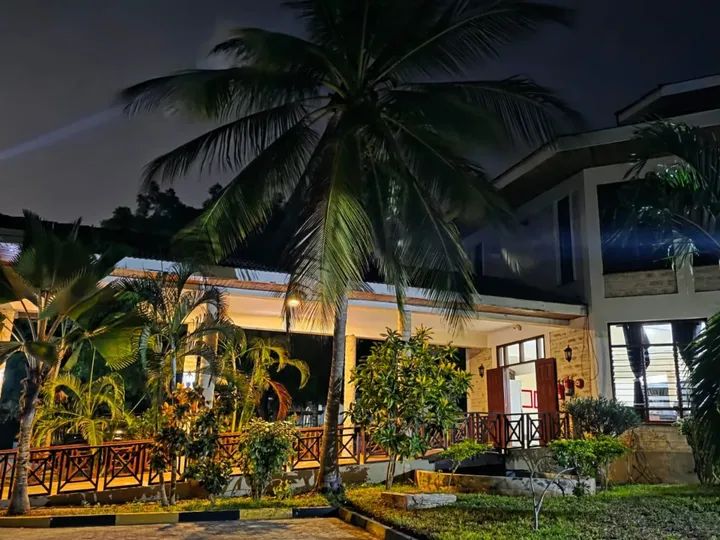 Resort entrance and gardens lit up at night